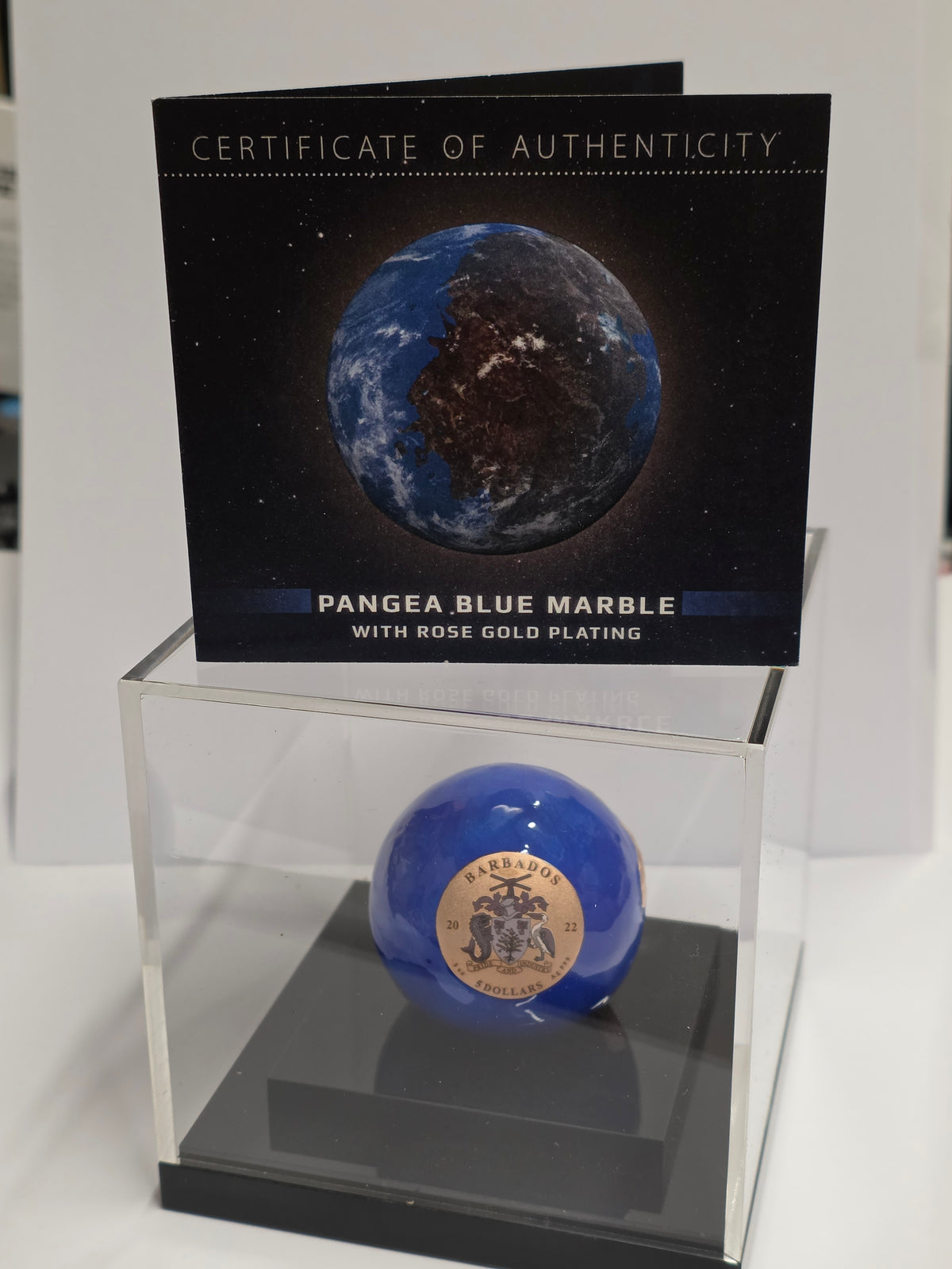 2022 Barbados 5$ Pangea Blue Marble Rose Gold Plated Spherical 3 oz Silver Coin in a display case with its certificate of authenticity